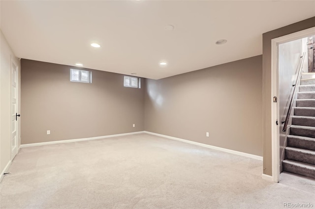 basement featuring light carpet