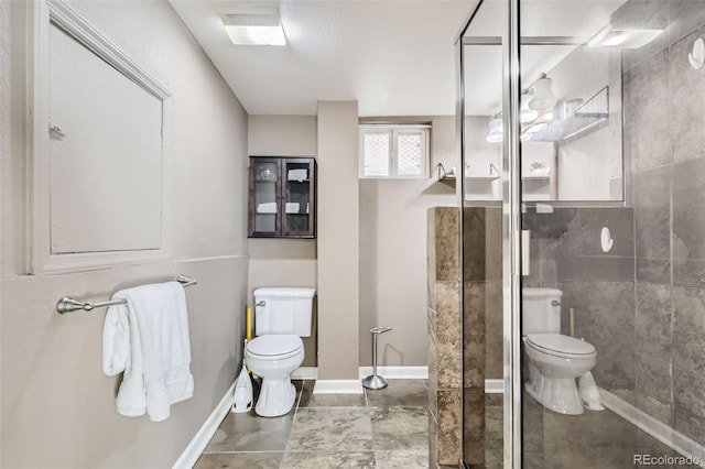 bathroom featuring tile patterned floors, toilet, and an enclosed shower