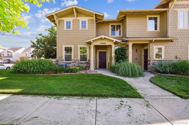 10480 Truckee St Unit B, Commerce City, CO 80022 - view of front of property featuring a front lawn and stone siding