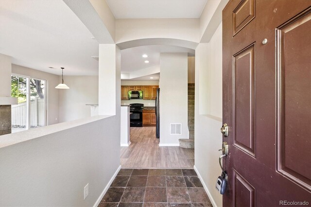 10480 Truckee St Unit B, Commerce City, CO 80022 - foyer with arched walkways and recessed lighting