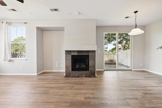 10480 Truckee St Unit B, Commerce City, CO 80022 - unfurnished living room featuring a fireplace, wood finished floors, and ceiling fan