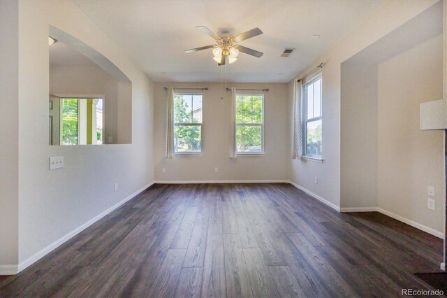 10480 Truckee St Unit B, Commerce City, CO 80022 - unfurnished room featuring dark wood finished floors, ceiling fan, and arched walkways