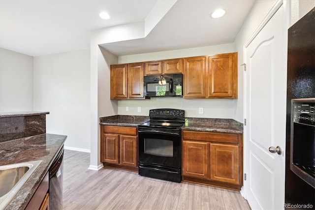 10480 Truckee St Unit B, Commerce City, CO 80022 - kitchen with black appliances, light wood finished floors, brown cabinetry, recessed lighting, and dark stone counters