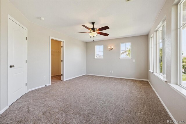 10480 Truckee St Unit B, Commerce City, CO 80022 - unfurnished bedroom featuring carpet floors, a walk in closet, and ceiling fan