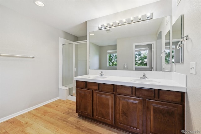 10480 Truckee St Unit B, Commerce City, CO 80022 - full bath with a shower stall, double vanity, and wood finished floors