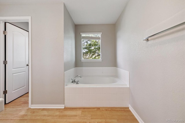 10480 Truckee St Unit B, Commerce City, CO 80022 - full bathroom featuring wood finished floors and a bath
