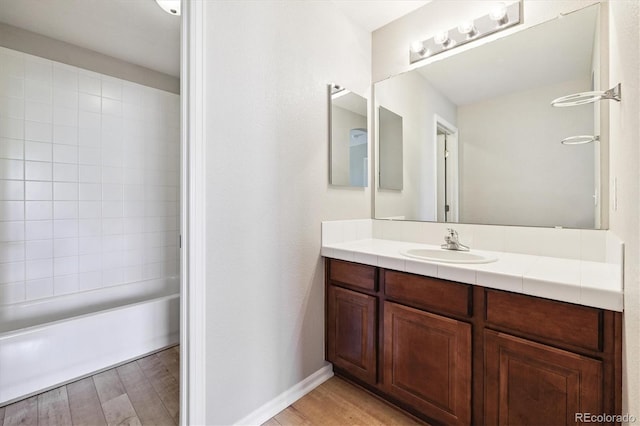 10480 Truckee St Unit B, Commerce City, CO 80022 - full bathroom featuring vanity, wood finished floors, and bathtub / shower combination