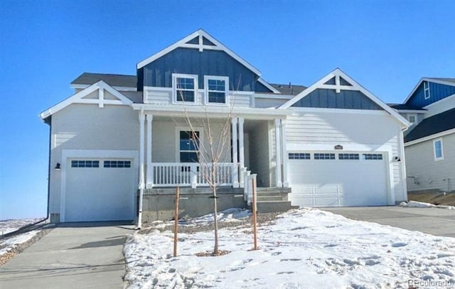 view of front of house featuring an attached garage, covered porch, board and batten siding, and concrete driveway