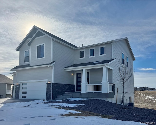 view of front of home featuring a porch, central air condition unit, a garage, driveway, and stone siding