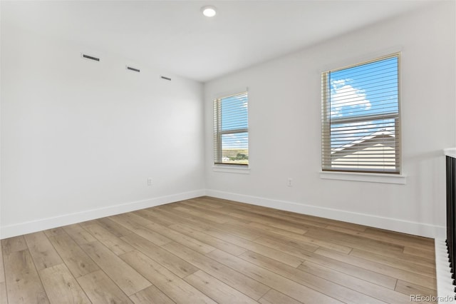 empty room with light wood-style floors and baseboards