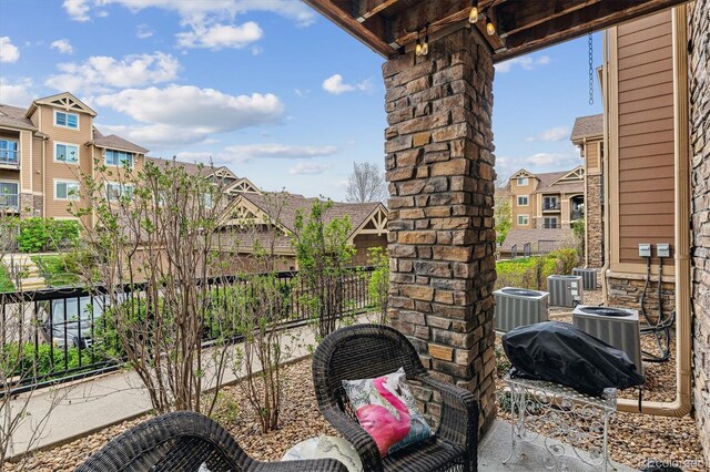 view of patio / terrace with central AC unit and a residential view