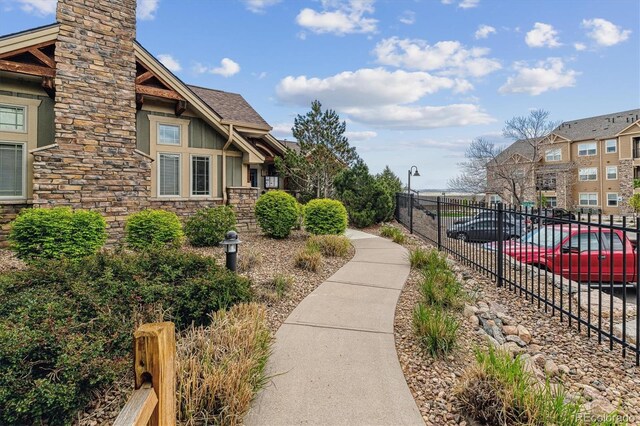view of property's community featuring fence