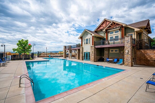 pool featuring a patio area and fence