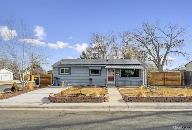 single story home featuring solar panels