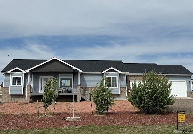 single story home featuring covered porch, stairs, a garage, and brick siding