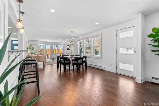 dining area featuring a wall mounted AC, a baseboard radiator, dark hardwood / wood-style floors, and an inviting chandelier