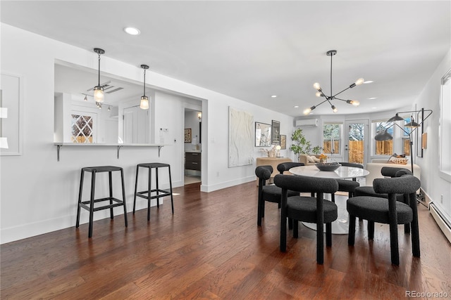 dining room featuring an inviting chandelier, dark hardwood / wood-style flooring, and a wall mounted AC