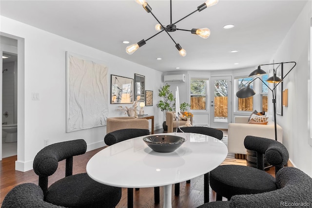 dining space featuring a wall mounted air conditioner, wood-type flooring, and a notable chandelier