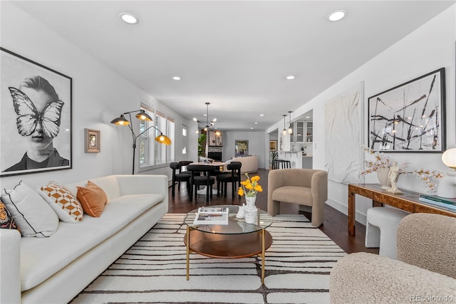 living room featuring hardwood / wood-style floors and an inviting chandelier