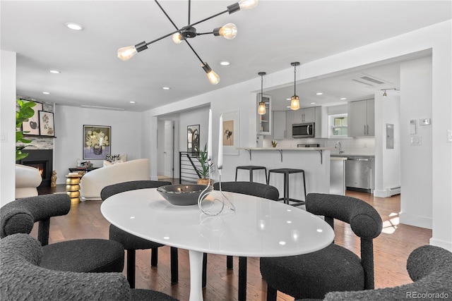 dining space featuring light hardwood / wood-style flooring and sink