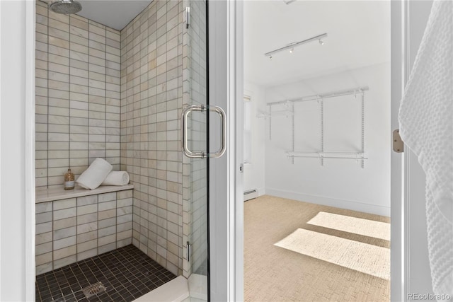 bathroom featuring a shower with door and a baseboard radiator