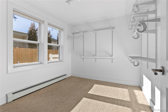 walk in closet featuring carpet flooring and baseboard heating