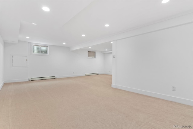 basement with light colored carpet and a baseboard radiator