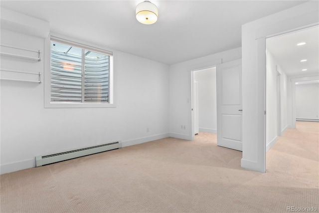 unfurnished bedroom with light carpet and a baseboard radiator