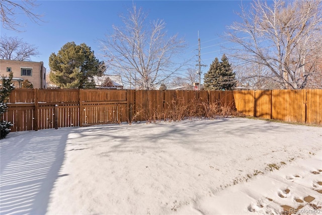 view of yard layered in snow