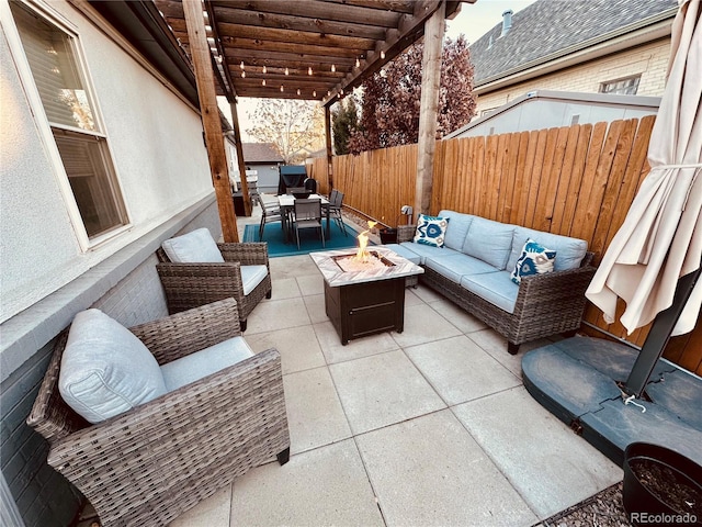 view of patio featuring an outdoor living space with a fire pit