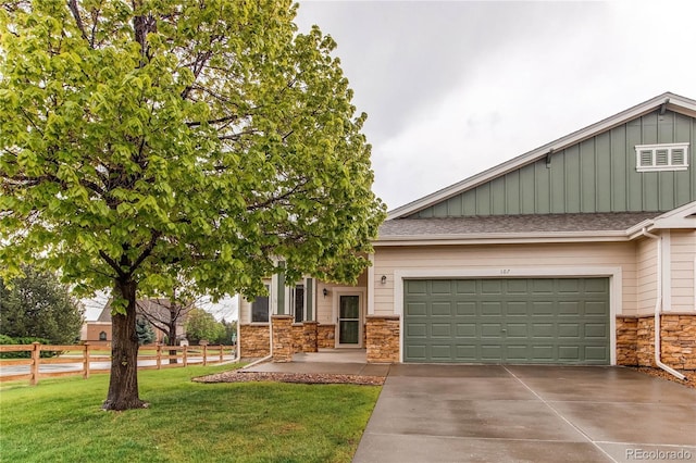 107 Carina Cir, Loveland, CO 80537 - view of front of home featuring stone siding, driveway, board and batten siding, an attached garage, and roof with shingles