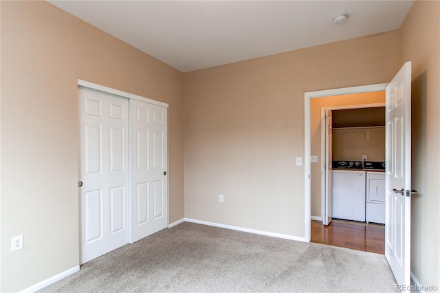 107 Carina Cir, Loveland, CO 80537 - unfurnished bedroom with washing machine and clothes dryer, carpet, baseboards, and a closet