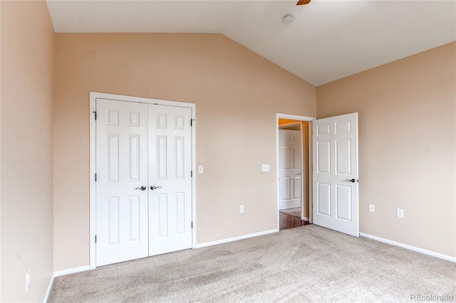 107 Carina Cir, Loveland, CO 80537 - unfurnished bedroom featuring vaulted ceiling, carpet flooring, a closet, baseboards, and ceiling fan