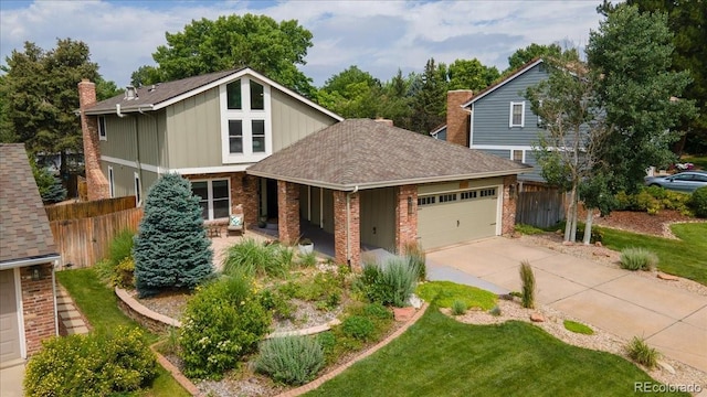 8167 S Wabash Ct, Centennial, CO 80112 - view of front of property featuring an attached garage, concrete driveway, brick siding, and roof with shingles