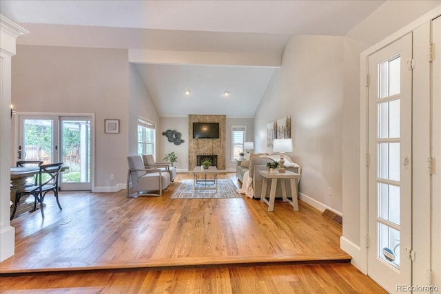 8167 S Wabash Ct, Centennial, CO 80112 - living area with wood finished floors, a large fireplace, and lofted ceiling
