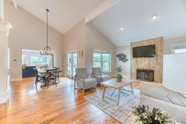 8167 S Wabash Ct, Centennial, CO 80112 - living area with high vaulted ceiling, light wood-type flooring, a fireplace, a chandelier, and recessed lighting