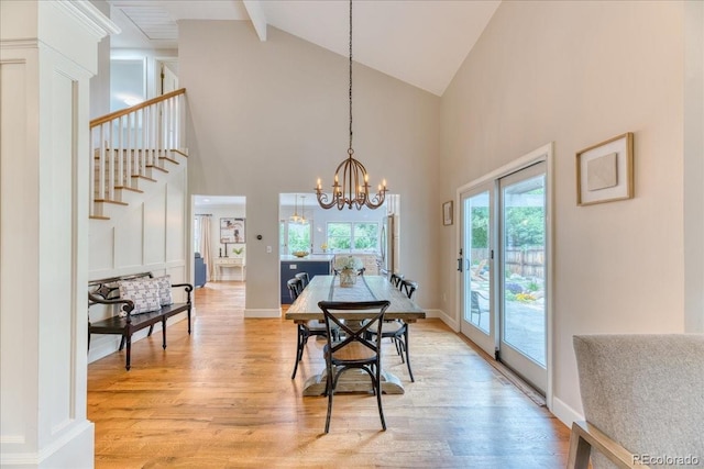 8167 S Wabash Ct, Centennial, CO 80112 - dining area with high vaulted ceiling, light wood finished floors, stairs, a chandelier, and beamed ceiling