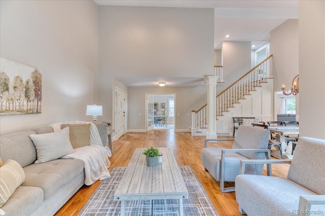8167 S Wabash Ct, Centennial, CO 80112 - living room featuring a towering ceiling, stairway, plenty of natural light, wood finished floors, and recessed lighting
