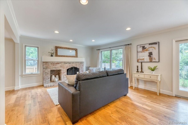 8167 S Wabash Ct, Centennial, CO 80112 - living room with ornamental molding, light wood-type flooring, healthy amount of natural light, a fireplace, and recessed lighting