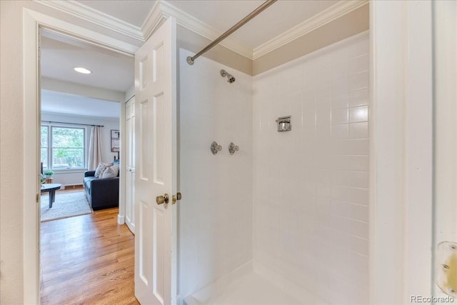 8167 S Wabash Ct, Centennial, CO 80112 - bathroom with tiled shower, wood finished floors, and crown molding