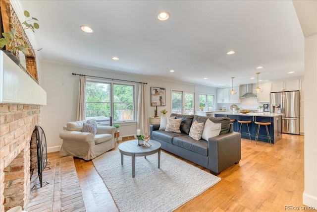 8167 S Wabash Ct, Centennial, CO 80112 - living room with ornamental molding, light wood-type flooring, a fireplace, and recessed lighting