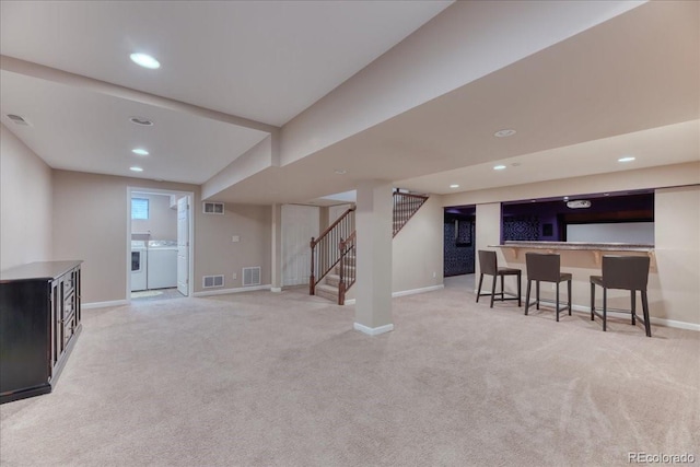 8167 S Wabash Ct, Centennial, CO 80112 - below grade area featuring independent washer and dryer, carpet flooring, stairs, recessed lighting, and bar
