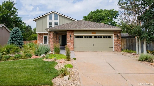 8167 S Wabash Ct, Centennial, CO 80112 - view of front of home with brick siding, an attached garage, driveway, board and batten siding, and a shingled roof