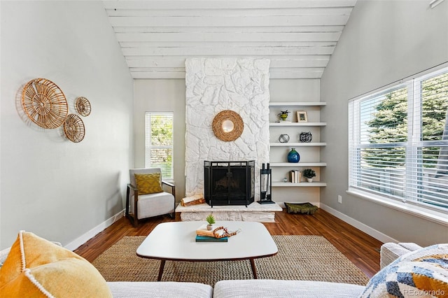 living room featuring vaulted ceiling, baseboards, a fireplace, wood finished floors, and wood ceiling