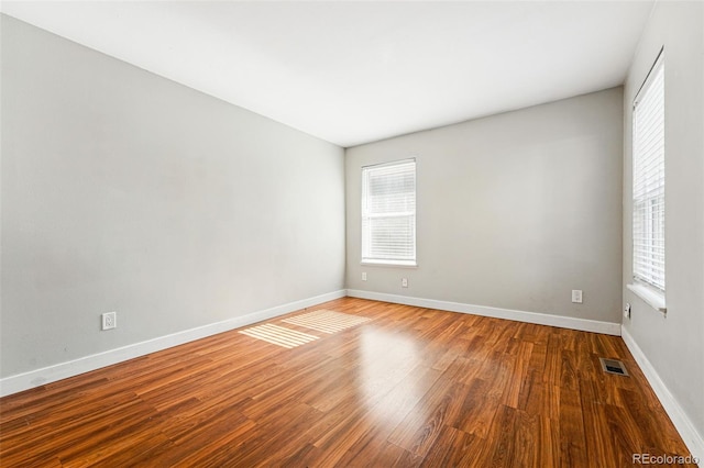 unfurnished room featuring wood finished floors and baseboards