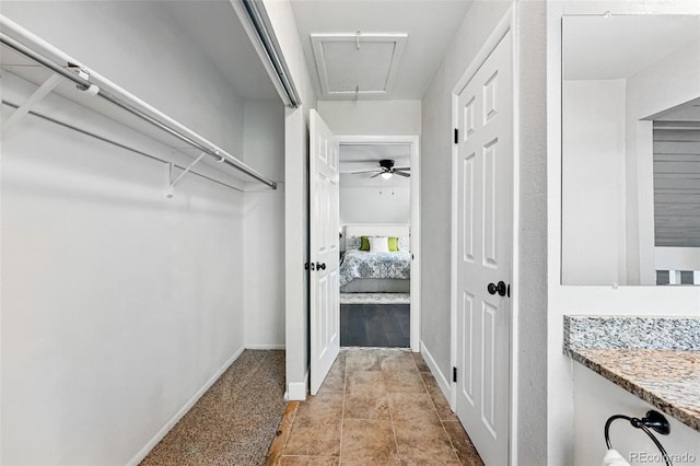 spacious closet featuring attic access