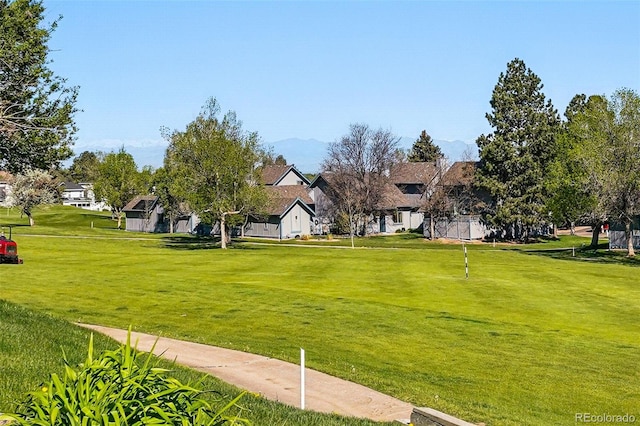 view of home's community featuring a residential view and a lawn