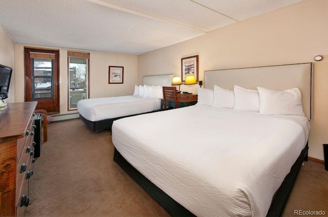 carpeted bedroom with a baseboard heating unit and a textured ceiling