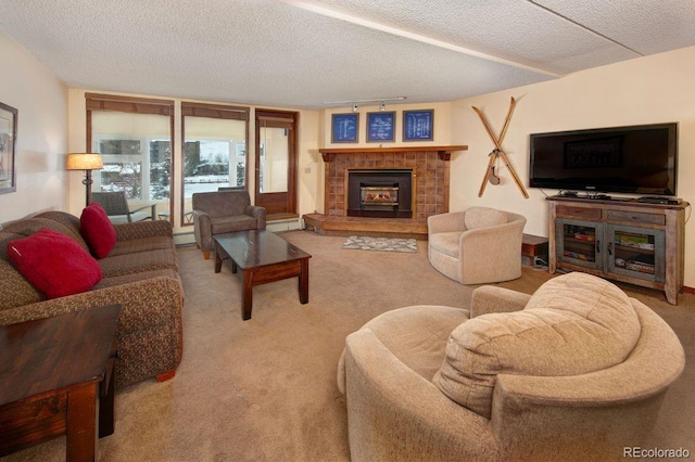 living room featuring carpet flooring, a textured ceiling, and a tile fireplace