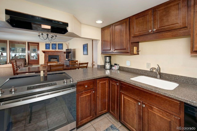 kitchen featuring light tile patterned floors, stainless steel range with electric stovetop, sink, and black dishwasher